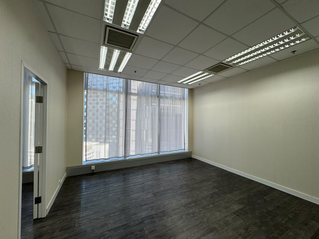 Newly renovated private room with sheer curtains and a dark wood floor